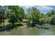 Scenic aerial view of a charming lakefront home with dock surrounded by lush trees at 4599 B & C Dr, Catawba, NC 28609