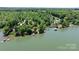 Expansive aerial view showcasing a waterfront estate with docks, mature trees, and scenic lake views at 4599 B & C Dr, Catawba, NC 28609