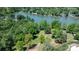 Picturesque aerial view of a waterfront property surrounded by lush trees and a serene lake at 4599 B & C Dr, Catawba, NC 28609