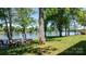 Scenic backyard view with a wooden deck, lush green grass, and a tranquil lake at 4599 B & C Dr, Catawba, NC 28609