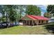 Lake house with a red roof, screened porch, and landscaped lawn leading to the water at 4599 B & C Dr, Catawba, NC 28609
