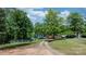 Scenic view of a charming lakefront property with a red roof and tree-lined driveway at 4599 B & C Dr, Catawba, NC 28609