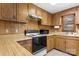 This retro kitchen features wood cabinets, laminate countertops, and essential appliances for a functional cooking space at 4599 B & C Dr, Catawba, NC 28609
