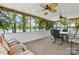Relaxing sunroom with lake views through large windows, complemented by comfortable seating and ceiling fans at 4599 B & C Dr, Catawba, NC 28609