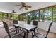 Relaxing sunroom with lake views through large windows, complemented by comfortable seating and ceiling fans at 4599 B & C Dr, Catawba, NC 28609