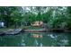 Picturesque waterfront home with a private dock and gazebo reflected in the calm water, surrounded by lush green trees at 4599 B & C Dr, Catawba, NC 28609