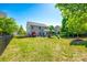 Expansive fenced backyard with a patio, play set, and lush greenery at 5070 Saint Clair St, Fort Mill, SC 29715