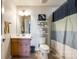 This bathroom features a modern shower curtain, open shelving, and stylish fixtures, enhancing the space at 5070 Saint Clair St, Fort Mill, SC 29715