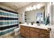 Well-lit bathroom featuring a double sink vanity and a striped shower curtain for a clean, modern look at 5070 Saint Clair St, Fort Mill, SC 29715
