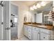 Bright bathroom featuring dual sinks, granite countertops, and modern fixtures with views into the bedroom at 5070 Saint Clair St, Fort Mill, SC 29715