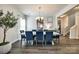 Elegant dining room with a large table, blue chairs, and modern chandelier at 5070 Saint Clair St, Fort Mill, SC 29715