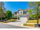 Street view of a two-story home with stone facade, attached garage, and an American flag at 5070 Saint Clair St, Fort Mill, SC 29715