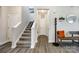 Inviting foyer with stairs, a bench with pillows and coat rack creating a welcoming entry at 5070 Saint Clair St, Fort Mill, SC 29715