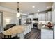 Bright kitchen with white cabinets, stainless steel appliances, and a large granite island at 5070 Saint Clair St, Fort Mill, SC 29715