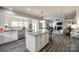 Open concept: kitchen island with granite countertops, stainless appliances, and hardwood flooring at 5070 Saint Clair St, Fort Mill, SC 29715