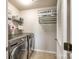 Efficient laundry room equipped with modern washer and dryer, complemented by ample shelving for storage at 5070 Saint Clair St, Fort Mill, SC 29715