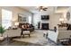 Well-lit living room featuring a fireplace, ceiling fan, and leather seating at 5070 Saint Clair St, Fort Mill, SC 29715