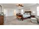 Large main bedroom features a seating area, dark wood furnishings, a ceiling fan and great natural light at 5070 Saint Clair St, Fort Mill, SC 29715