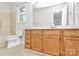 Traditional bathroom with a vanity and framed mirror, toilet and a window at 5114 Daffodil Ln, Concord, NC 28025