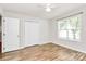 Bedroom features a closet, wood flooring, and natural light from a window at 5114 Daffodil Ln, Concord, NC 28025