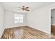 Bright bedroom with hardwood flooring, ceiling fan and a large window at 5114 Daffodil Ln, Concord, NC 28025