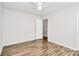 Bright bedroom with white ceiling fan and door leading to a bathroom at 5114 Daffodil Ln, Concord, NC 28025