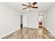 Bright bedroom with hardwood flooring, and white door leading to the bathroom at 5114 Daffodil Ln, Concord, NC 28025