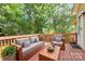 Cozy outdoor living on the wooden deck, featuring stylish seating and a tranquil setting at 5114 Daffodil Ln, Concord, NC 28025