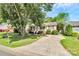 Inviting single-story home with a long driveway and well-maintained lawn and landscaping at 5114 Daffodil Ln, Concord, NC 28025