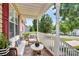 Comfortable front porch seating area with stylish white furniture and a view of the neighborhood at 5114 Daffodil Ln, Concord, NC 28025