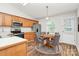 Well-lit kitchen with wood cabinets, stainless steel appliances, and an adjacent dining area at 5114 Daffodil Ln, Concord, NC 28025