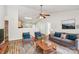 Bright living room featuring a ceiling fan, modern furniture, and an open layout into the kitchen at 5114 Daffodil Ln, Concord, NC 28025