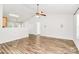 Spacious living room with hardwood floors and a view to the kitchen through a half wall at 5114 Daffodil Ln, Concord, NC 28025