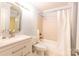 Clean bathroom with vanity and tiled shower-tub combo at 525 N Graham St, Charlotte, NC 28202