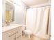 Bathroom featuring a vanity, mirror, and a shower-tub combo at 525 N Graham St, Charlotte, NC 28202