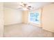 Spacious bedroom with neutral carpet, ceiling fan, and a bright window at 525 N Graham St, Charlotte, NC 28202