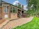 Back of house with brick patio and outdoor living space overlooking lush lawn at 5624 Warewhip Ln, Charlotte, NC 28210