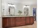 This bathroom includes dual sinks, granite countertops, and dark wood cabinets at 5624 Warewhip Ln, Charlotte, NC 28210