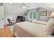 Bright bedroom features two beds, a large window, ceiling fan, desk and rocker at 5624 Warewhip Ln, Charlotte, NC 28210