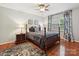 Bedroom with hardwood flooring, and dark patterned curtains, creating a cozy space at 5624 Warewhip Ln, Charlotte, NC 28210