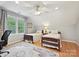 Bright bedroom features two beds, a large window, ceiling fan, and a decorative rug at 5624 Warewhip Ln, Charlotte, NC 28210