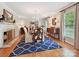 Elegant dining room with a fireplace, hardwood floors, and lots of natural light at 5624 Warewhip Ln, Charlotte, NC 28210