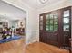 Inviting foyer featuring hardwood floors and a view into the formal dining room at 5624 Warewhip Ln, Charlotte, NC 28210