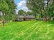 Charming brick home featuring a large, well-manicured lawn and mature trees at 5624 Warewhip Ln, Charlotte, NC 28210
