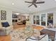 An expansive living room showcases hardwood floors, ceiling fan, and access to a brick-paved outdoor patio at 5624 Warewhip Ln, Charlotte, NC 28210