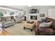 Comfortable living room with a white-brick fireplace, mounted television, and plush seating, perfect for relaxation at 5624 Warewhip Ln, Charlotte, NC 28210