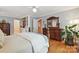 A primary bedroom with wood floors, built-in shelving, a view of an ensuite, and a walk-in closet at 5624 Warewhip Ln, Charlotte, NC 28210