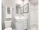 Well-lit, compact bathroom features a toilet, vanity with a mirror, and towel racks for convenience at 5782 Knox Ln, Kannapolis, NC 28081