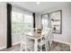 Sunlit dining area features a wood table, seating for six, large windows and stylish décor at 5782 Knox Ln, Kannapolis, NC 28081