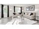 Inviting living room features two sofas, a glass coffee table, and large windows for abundant natural light at 5782 Knox Ln, Kannapolis, NC 28081